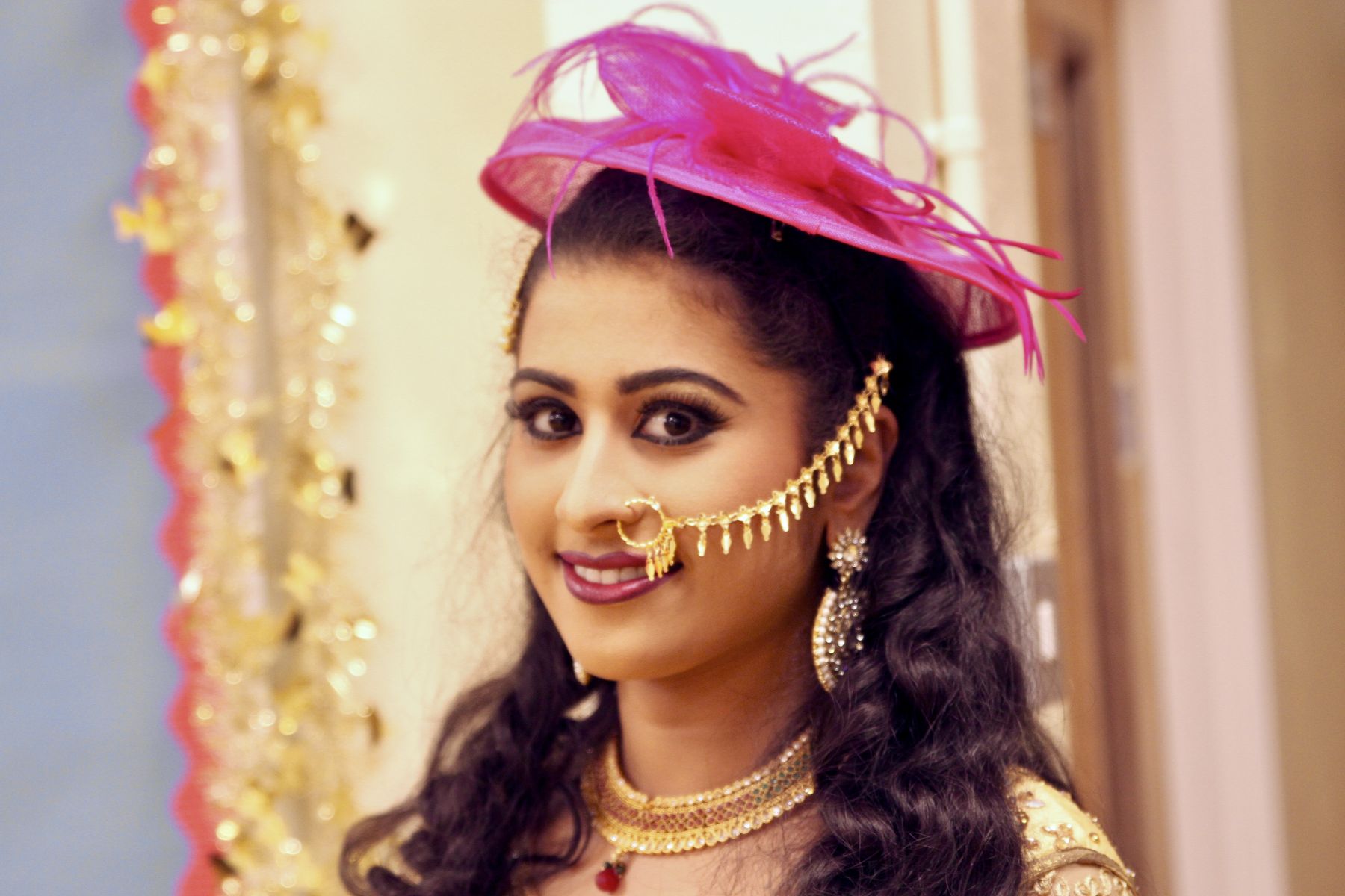 Bride in traditional jewellery and a pink fascinator