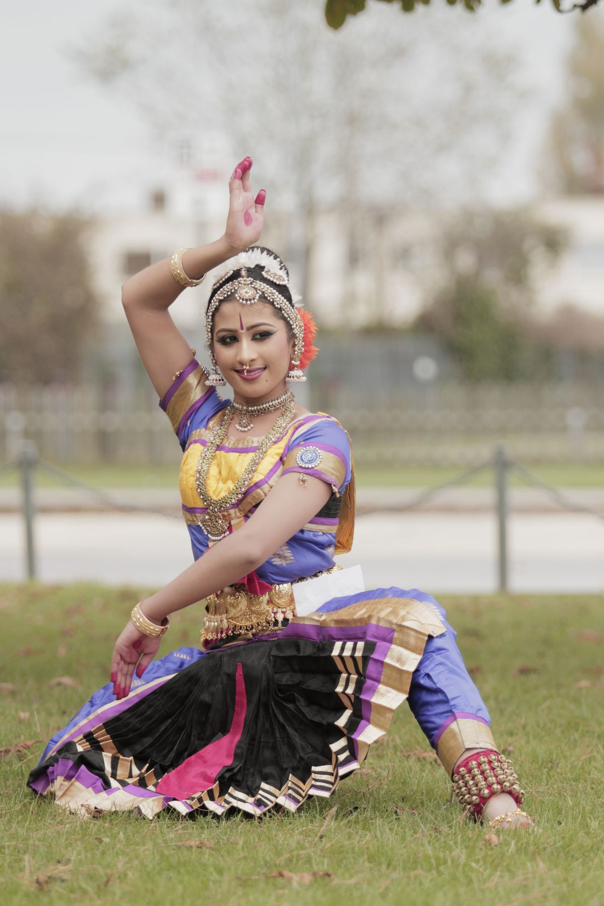 Classical dancer in full costume posing on the grass